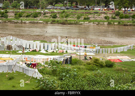 Outdoor laundry service on the river bank of Ganga - Haridwar, India. Stock Photo