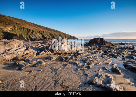 Rocks at low tide on Hemmick Beach on the south coast of Cornwall Stock Photo