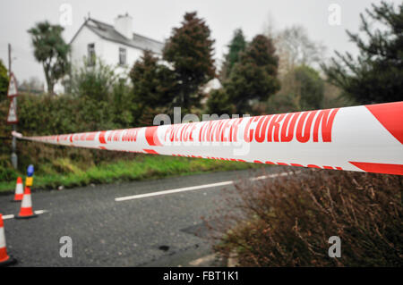 Police 'Inner Cordon' tape is stretched across a road at the scene of a murder investigation. Stock Photo