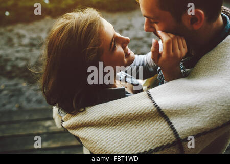 Young couple wrapped in plaid Stock Photo