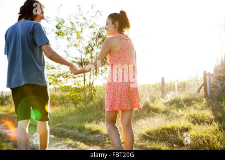 Young couple walking together along countryside footpath Stock Photo