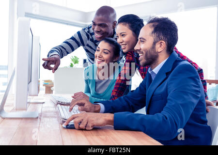 Cheerful business people looking at computer screen Stock Photo