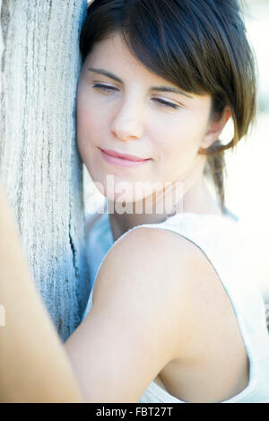 Woman hugging tree Stock Photo