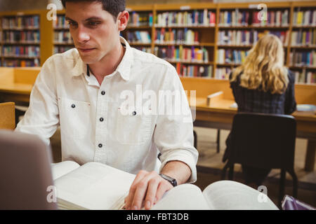 Focused student using his laptop while working Stock Photo