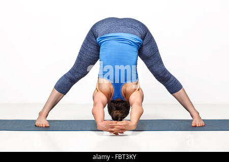 Woman doing yoga asana Prasarita padottanasana Stock Photo