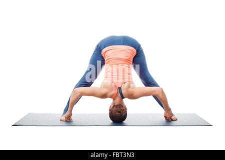 Woman doing yoga asana Prasarita padottanasana Stock Photo