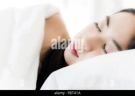 Woman sleeping in bed, close-up