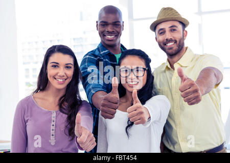 Portrait of creative business people showing thumbs up Stock Photo