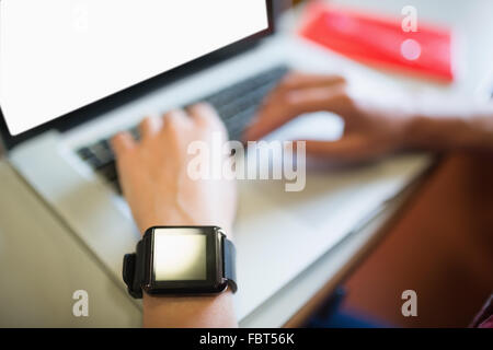 Cropped image of female student using laptop Stock Photo