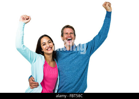 Successful couple with hands raised Stock Photo