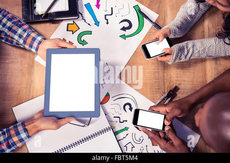 Overhead view of creative business people working at desk Stock Photo