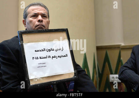 Cairo, Egypt. 19th Jan, 2016. Tawfiq Okasha, a pro-government TV anchorman who was elected to parliament, sits in an anteroom and holds banners against Civil Service Law during a parliamentary session, in Cairo, Egypt in Jan. 19, 2016 © Amr Sayed/APA Images/ZUMA Wire/Alamy Live News Stock Photo