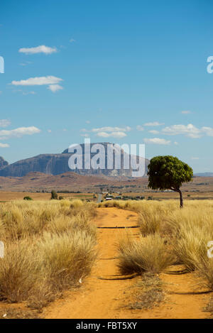 Dirt road with Bishop's Hat Rock in the background, Madagascar Stock Photo