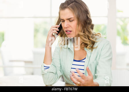 Frowning woman having phone call Stock Photo