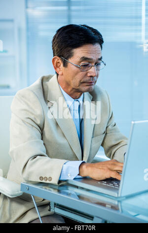 Focused businessman using laptop Stock Photo