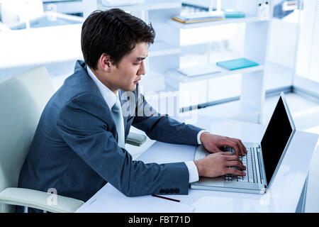 Serious asian businessman using his computer Stock Photo