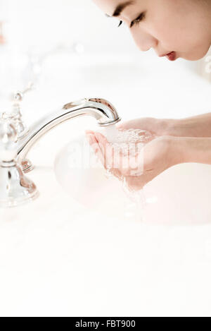 Woman washing her face Stock Photo