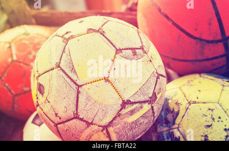 Vintage old film stylized used balls in a basket, shallow depth of field. Stock Photo