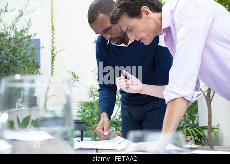 Businessmen discussing documents Stock Photo