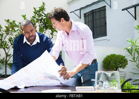 Architects discussing blueprint Stock Photo