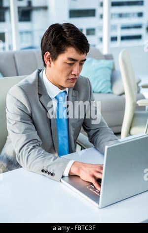 Concentrated businessman typing on computer Stock Photo