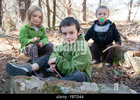 Children playing in woods Stock Photo