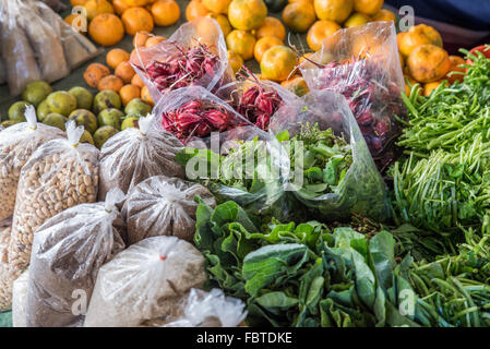 Indian market.  A plethora of healthy fresh vibrant produce. Fresh green leaves, Citrus fruits, oranges and bags of beans and pulses. Kohima, India Stock Photo
