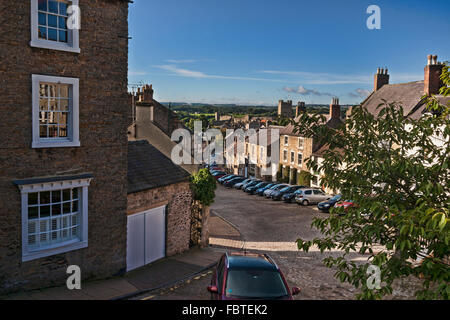 Looking down cobbled street to Richmond Castle, North Yorkshire, England Stock Photo