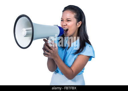 Businesswoman shouting into a megaphone Stock Photo