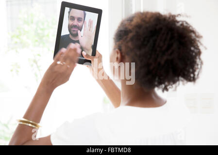 Using digital tablet to video conference Stock Photo