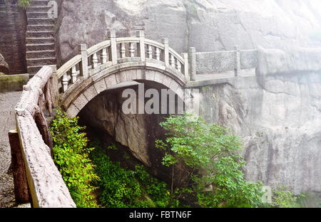 Foggy Stone bridge in Huangshan mountains Stock Photo