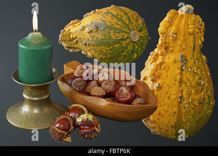 candle, chestnuts and pumpkins Stock Photo