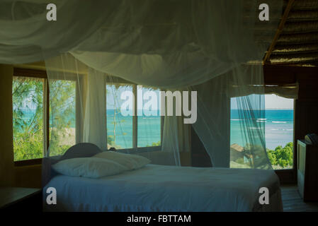 Mosquito netting over bed in hotel room Stock Photo