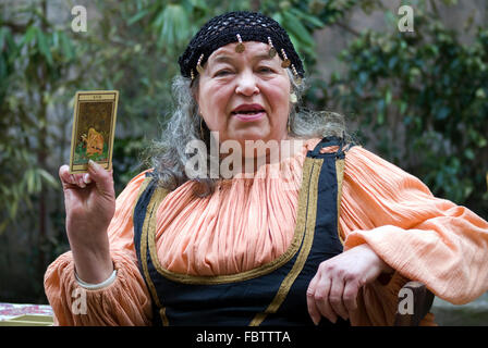 Portrait of old mature fortune teller looking into illuminated crystal ...