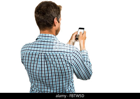 Rear view of man using smartphone Stock Photo