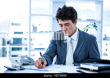 Concentrated asian businessman Stock Photo