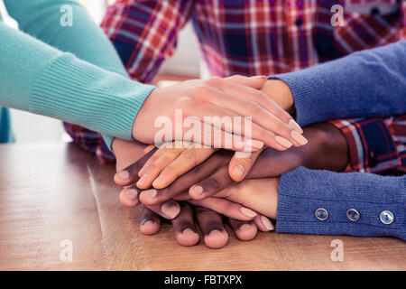 Business people with stacked hands on desk Stock Photo