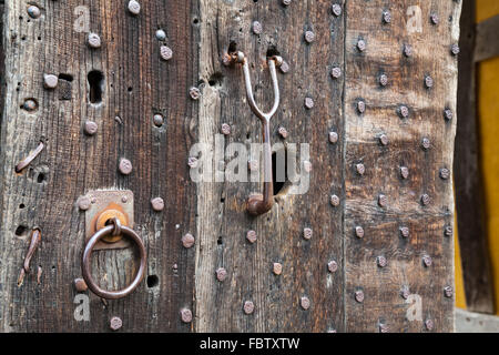 Heavily studded oak door at entrance to castle Stock Photo