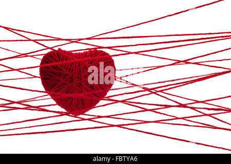Red heart made from wool isolated on white background Stock Photo