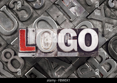 logo concept made from metallic letterpress blocks on many letters background Stock Photo