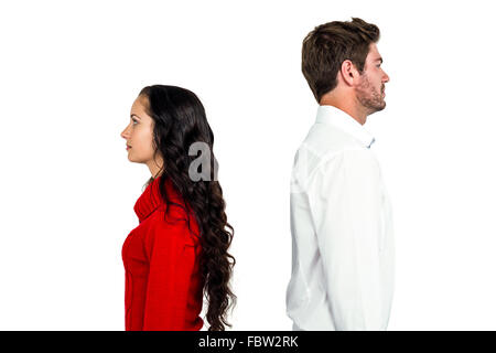 Couple standing back to back after arguing Stock Photo