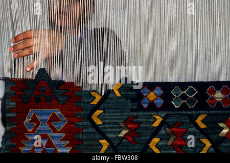 Turkey, Anatolia, Cappadocia, Göreme, carpet weaving, loom and hands close up Stock Photo