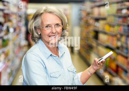 Smiling senior woman using smartphone Stock Photo
