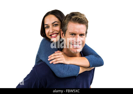Portrait of cheerful man carrying girlfriend on back Stock Photo