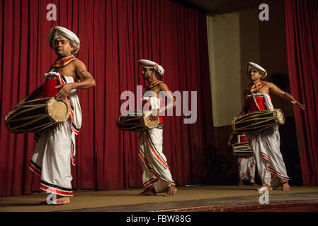 A group of Kandyan drummers part of the Kandyan dance, on stage at a YMBA ( Young Men's Buddhist Association) Hall in Ksndy Stock Photo