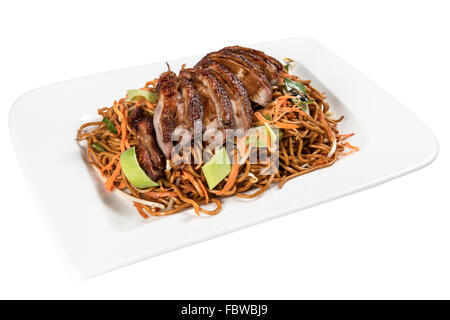 Chinese Food on a white Plate with roast Duck, vegetable and fried Noodles. Background white isolated Stock Photo