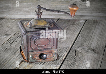 Old coffee grinder on a wooden table Stock Photo