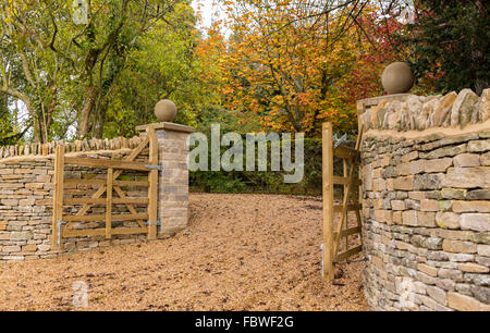 Open wooden gates at entrance to modern house Stock Photo