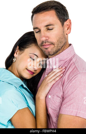 Peaceful couple hugging with eyes closed Stock Photo