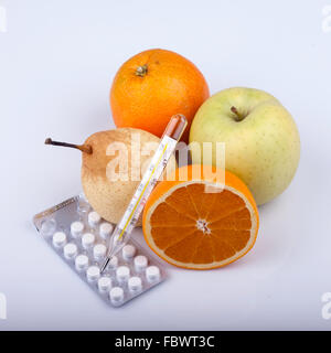 lot of fruits, pills and thermometer on white Stock Photo